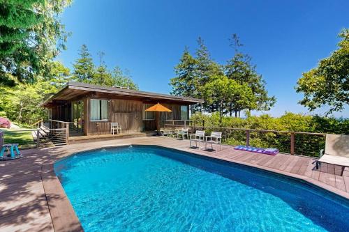 a swimming pool with a patio and a house at The Eliot Noyes in Chilmark
