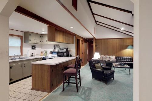 a kitchen and living room with a counter and chairs at Island Getaway in Oak Bluffs