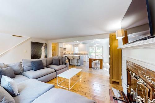 a living room with a couch and a fireplace at Osprey View Villa in Dennis