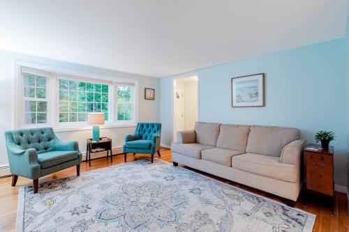 a living room with a couch and two chairs at Collingwood Cottage in Yarmouth Port