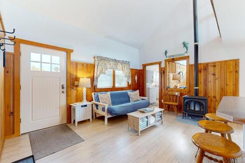 a living room with a blue couch and a fireplace at Trotting Park Paradise in West Dennis