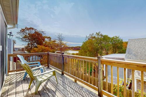 a deck with a chair and a view of the water at Trotting Park Paradise in West Dennis