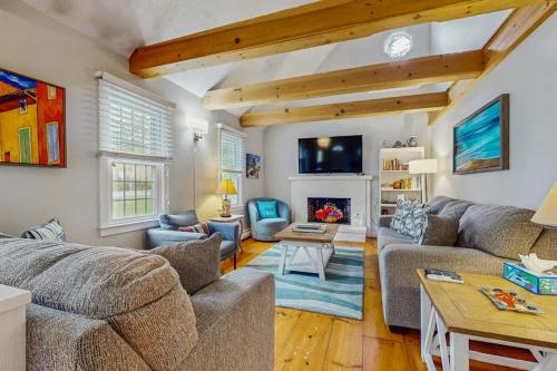 a living room with two couches and a fireplace at Cozy Charming Cottage in Brewster