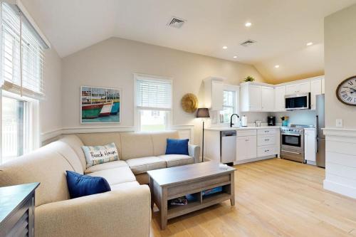 a living room with a couch and a table at The Quintessential Cape Cottage in Orleans