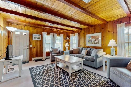 a living room with a couch and a table at Cape Beach Bungalow in Dennis Port