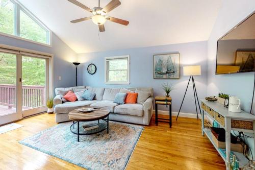 a living room with a couch and a table at Birch Grove in Mashpee