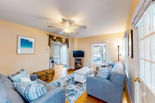 a living room with two couches and a ceiling fan at Onset Grove in Onset