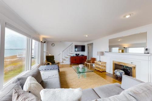 a living room with a couch and a fireplace at Kalmus Park Retreat in Hyannis