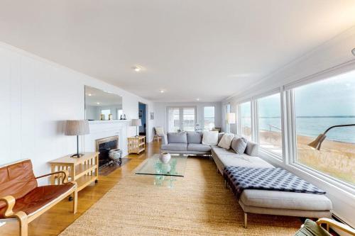 a living room with a couch and a fireplace at Kalmus Park Retreat in Hyannis