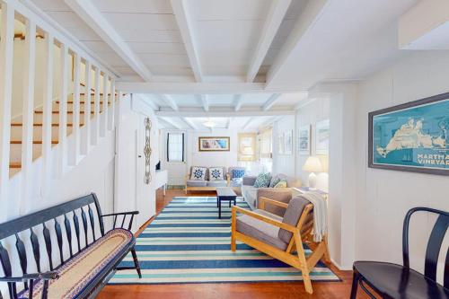 a living room with two chairs and a couch at Canary Cottage in Oak Bluffs