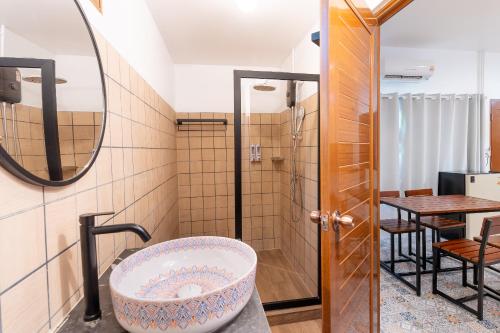 a bathroom with a large bath tub and a table at Baan Old Town Boutique Stay, Phuket Town in Phuket