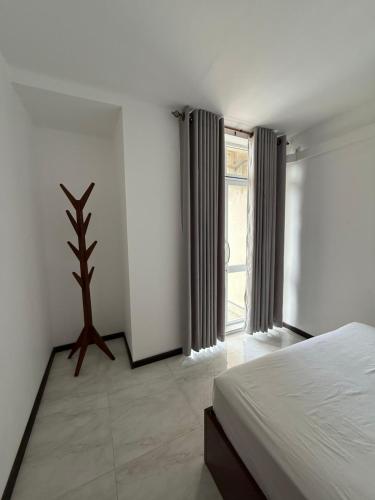 a bedroom with a bed and a large window at Lucky Homes in Maharagama