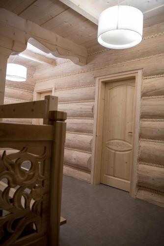 a room with wooden walls and a door at Apartamenty Augustynówka in Brzegi