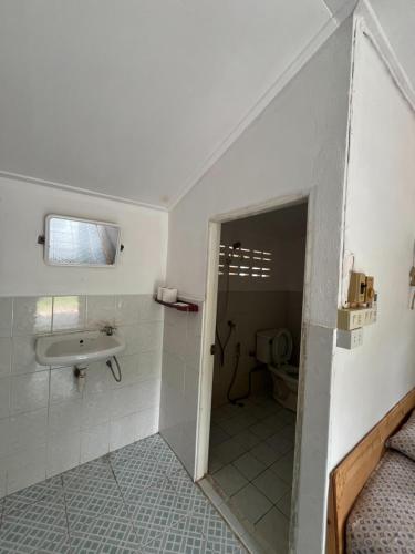 a bathroom with a sink and a toilet at Blue Lotus Resort in Ban Tai