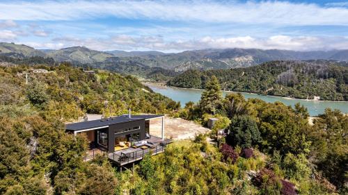 a house on a hill with a view of a river at Kokomea in Kaiteriteri