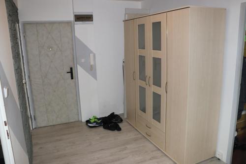 a room with a wardrobe and shoes on the floor at Liked home in Pernink