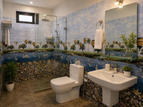 a bathroom with a toilet and a sink at Rainbow Safari & Lodge in Udawalawe