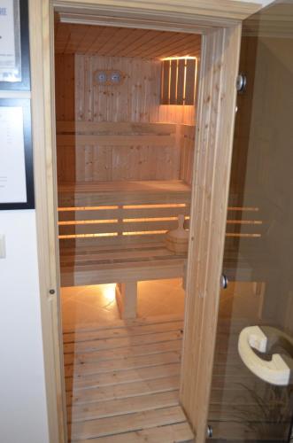 a wooden shower with a toilet in a room at Guest House Balchik Hills in Balchik