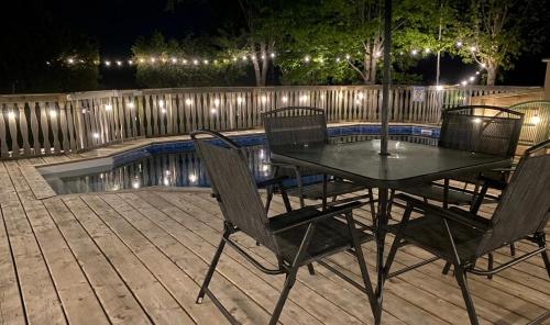 a table and chairs on a deck with a pool at South Shore Suites in Bayfield