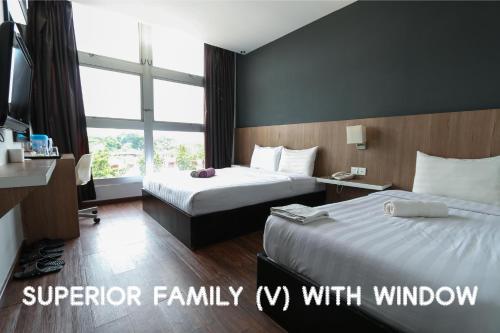 a hotel room with two beds and a window at Hotel 99 Botanik Klang in Klang