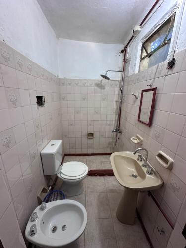 a bathroom with a toilet and a sink at Alojamiento Paz in Esquina