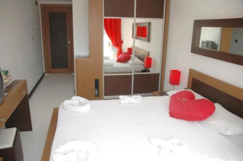 a bedroom with a bed with a red heart on it at Devamli Hotel in Marmaris
