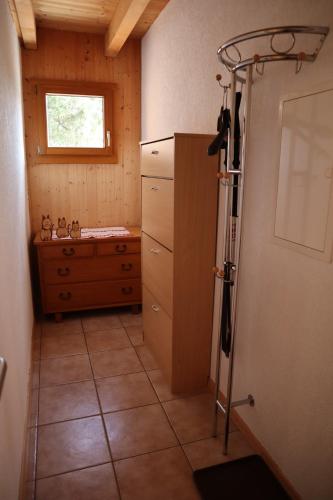 a small kitchen with a tiled floor and a window at Stöckli aux Fontaines in Tramelan