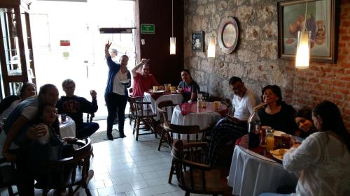 a group of people sitting at tables in a restaurant at Casa Limonchelo Hotel B&B in Morelia