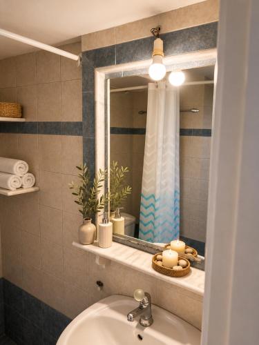 a bathroom with a sink and a mirror at Meltemi Apartments in Elafonisos