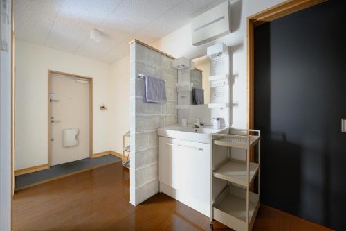 a small bathroom with a sink and a mirror at Building D - Vacation STAY 84939v in Bōchū