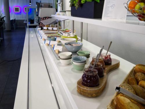 a buffet line with different types of pastries and desserts at Ibis budget Koeln Messe in Cologne