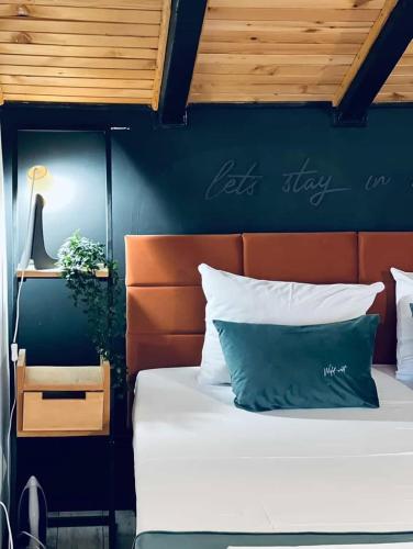 a bedroom with a bed and a blue wall at Zlatibor Wild nest Rabbit Lux in Zlatibor