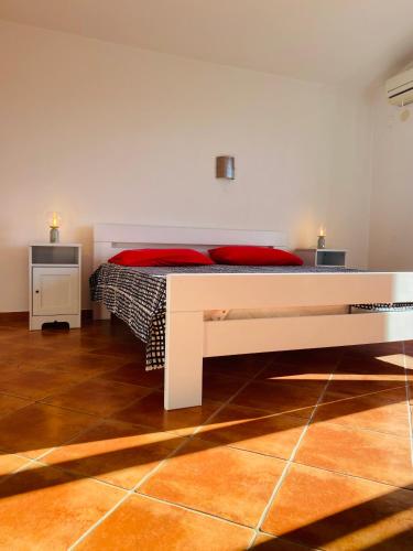 a bedroom with a large bed with red pillows at Salis in Novigrad Istria