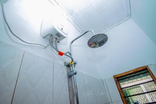 a shower in the corner of a room at Avana Studio Watamu in Watamu