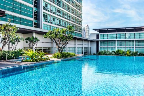 a large swimming pool in a large building at Pullman Bangkok King Power in Bangkok