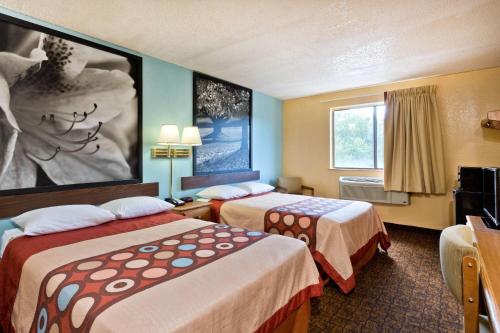 a hotel room with two beds and a window at Super 8 by Wyndham Lexington Park/California Area in California