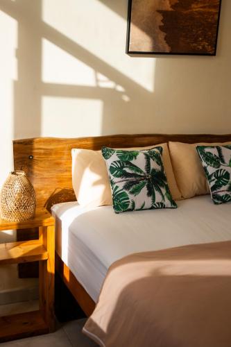 a bedroom with two beds and a wooden headboard at Les Manglier in Port Mathurin