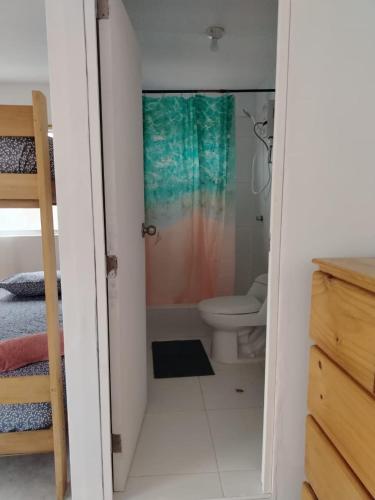 a small bathroom with a toilet and a shower at Cabañas Punta Negra in Punta Negra
