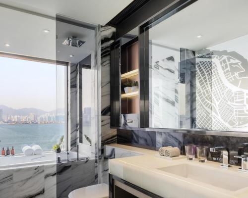 a bathroom with a sink and a large window at Hyatt Centric Victoria Harbour in Hong Kong