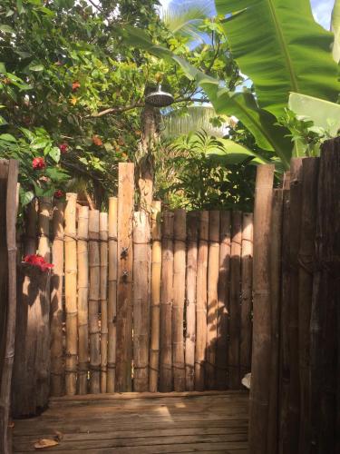a wooden fence in front of a garden at Oneta Resort in Ono Island