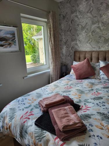 a bedroom with a bed with towels on it at Beech lodge in Wexford