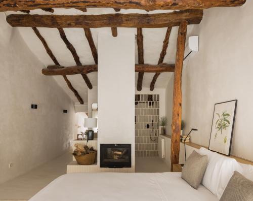 a bedroom with a bed and a fireplace at Casa Felicita in Casas de Pradas