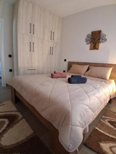 a large bed with two pillows on it in a bedroom at Elegance Apartments Mesologgi in Missolonghi