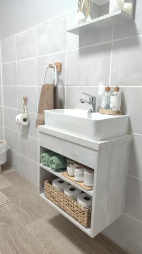 a bathroom with a white sink in a bathroom at Willowlea Cottage in Underberg