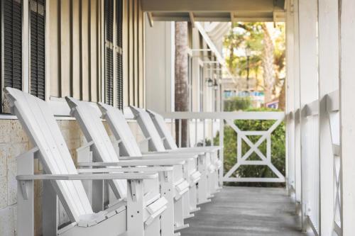 a row of white chairs sitting on a porch at Hampton Inn New Smyrna Beach in New Smyrna Beach