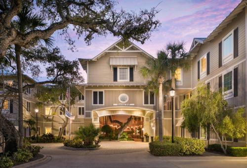 an exterior view of a house with palm trees at Hampton Inn New Smyrna Beach in New Smyrna Beach