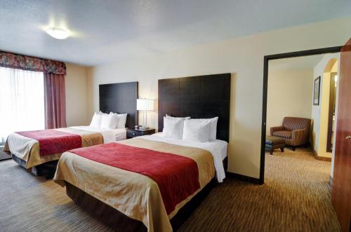 a hotel room with two beds and a chair at Comfort Inn & Suites Amarillo West Near Medical Center in Amarillo
