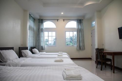 A bed or beds in a room at Plern Pitch Residence