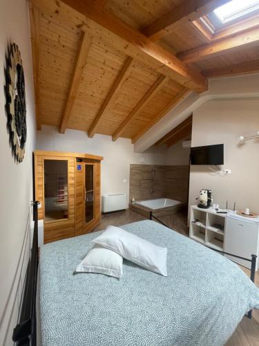 a bedroom with a large bed in a room with wooden ceilings at CAMILLA affitta camere in Nicolosi