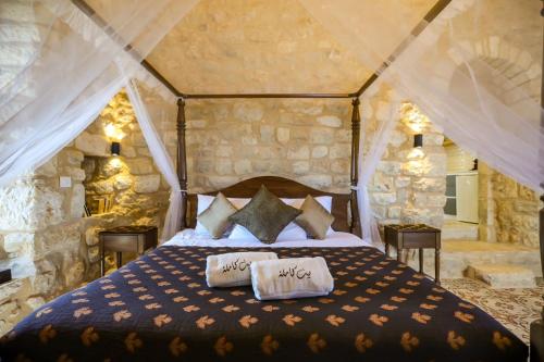 a bedroom with a bed with two pillows on it at Beitkamle in Batroûn